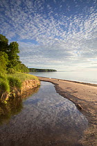 A beach at the edge of Lake Superior in the late afternoon. Apostle Islands National Lakeshore, Bayfield peninsula, Wisconsin, USA, July.