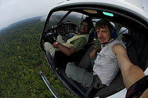 Anand Varma (left) and photographerTim Laman aboard a helicopter flying west of Yasuni National Park, Francisco de Orellana Province, Ecuador, July.