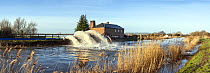 Panorama of River Parrett with massive jets of water from emergency pumps taking water off surrounding flooded fields. Near the village of Burrowbridge, Somerset Levels, Somerset, UK. January 2014. Di...