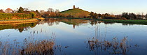 Panorama of Burrow Mump and its ruined hilltop church near Burrowbridge. In the foreground a swollen River Parrett on the right is joined by the River Tone on the left. Somerset Levels, Somerset, UK,...