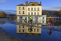 View of floodwater outside the Severn View Hotel, with cyclists, Worcester, England, UK, February 2014.