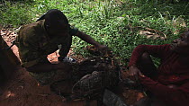 THIS VIDEO CLIP WILL BE AVAILABLE TO VIEW ONLINE SOON. TO VIEW NOW, PLEASE CONTACT US. -Ecoguard inspection of rucksacks containing bushmeat, Bayanga village, Dzanga-Ndoki National Park, Sangha-Mbaere...