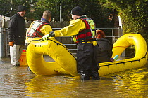 Rescue flood volunteers from Mercia Rescue Service with inflatable raft evacuating home owners during the February 2014 floods, Upton on Severn, Worcestershire, England, UK, 9th February 2014.