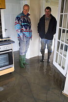 Man and neighbour in flooded cottage during February 2014, Upon upon Severn, Worcestershire, England, UK, 8th February 2014.