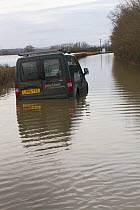 Abandoned van in flooded lane, during February 2014 flooding,  Severn valley, Gloucestershire, England, UK, 7th February 2014. Editorial use only.
