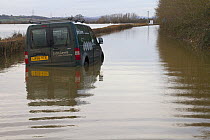 Abandoned van in flooded lane, during February 2014 flooding,  Severn valley, Gloucestershire, England, UK, 7th February 2014. Editorial use only.