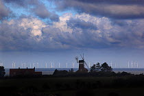 View looking towards Sherringham Shoal Windfarm, with Weybourne windmill silhouetted in the foreground, Norfolk, England, UK, November 2013.