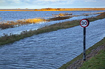 View of flooding on a coastal road after the 6th December east coast tidal surge, Cley, Norfolk, England, UK, December 2013.