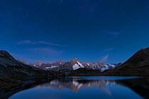 Stars over Fenetre Lake (Lac de Fenêtre in French) in Swiss Alps, 2456 m above sea level. Grande Jorasses, Aiguille du Talèfre, Aiguille du Triolet and Mont Dolent in Ferret Valley (Val Ferret) beyo...