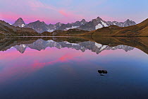 RF- Colourful pink sky at dawn above Fenetre Lake  / Lac de Fenetre in Swiss Alps, 2456 m above sea level. Mont Blanc, Grande Jorasses, Aiguille du Talefre, Aiguille du Triolet and Mont Dolent in Ferr...