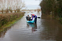 Man and woman in kayak during January 2014 floods in Somerset Levels, North Curry, England, UK, 10th January 2014.