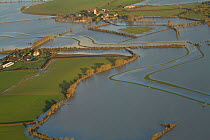 Muchelney village (with church and abbey) during January 2014 floods, showing flooded River Parrett, Somerset Levels, England, UK, 9th January 2014.