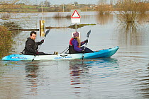 Couple in kayak during January 2014 flooding, North Curry, Somerset Levels, England, UK, 10th January 2014.
