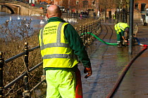 Worcester County Council workers starting the clean up process alongside River Severn following February 2014 floods, Worcester, England, UK, 22nd February 2014.