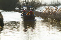 Rescue boat carrying flood victims to Muchelney during January 2014 floods, Somerset Levels, England, UK, 11th January 2014.
