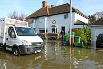 Van carrying sand bags to residents of flooded street, Weybridge, Surrey, England, UK, 10th February 2014.