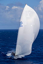 Mega yacht with white spinnaker racing in the 2013 St. Barths Bucket Regatta, March 2013, Caribbean. All non-editorial uses must be cleared individually.