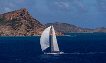Mega yacht racing downwind around island in the 2013 St. Barths Bucket Regatta, March 2013, Caribbean. All non-editorial uses must be cleared individually.