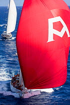 Mega yacht 'Adela' under spinnaker racing in the 2013 St. Barths Bucket Regatta, Caribbean, March 2013. All non-editorial uses must be cleared individually.