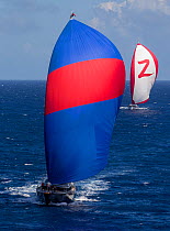 Mega yachts with spinnakers out during the 2013 St. Barths Bucket Regatta, Caribbean, March 2013. All non-editorial uses must be cleared individually.