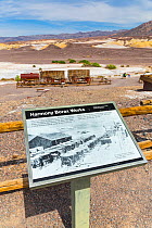 Sign and wagons at Harmony Borax Works, Death Valley National Park, California, USA, March 2013.
