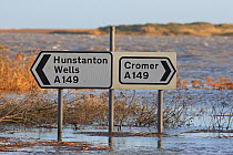 Road directions signs on flooded roads near Salthouse, Norfolk, England, UK, December 2013.