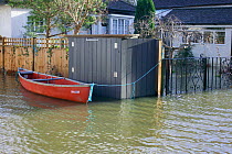 Canoe tethered outside flooded home during February 2014 flooding, Sunbury on Thames, Surrey, England, UK, 15th February 2014.