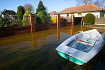 Boat tethered outside flooded home in February 2014 floods of River Thames, Wraysbury, Surrey, England, UK. 16th February 2014.