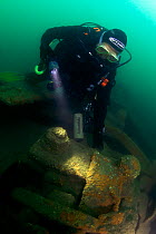 Diver on a main propellor shaft bearing on the wreck of the S.S. Serrana, sunk by UB-35 on 23 January 1918. Eastern Solent. England, UK, August 2013.