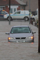 Car in floodwaters after sea defences were breached, at Splash Point in Rhyl, Denbighshire, Wales, 5th December 2013.
