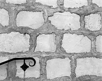 Black and white photograph of stone wall and hand rail at Mission, Santa Barbara, California, USA.
