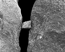 Black and white photograph of three rocks with one jammed between the other two, Washington, USA.