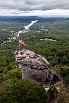 American stars and stripes flag on top of Chimney Rock in Chimney Rock State Park. North Carolina, USA, October 2013.