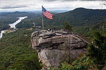 American Stars and stripes flag on top of Chimney Rock in Chimney Rock State Park. North Carolina, USA, October 2013.