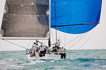 Boat with blue spinnaker out racing during 2013 Key West Race Week, Florida. All non-editorial uses must be cleared individually.