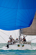 Sail boat racing under blue spinnaker during 2013 Key West Race Week, Florida. All non-editorial uses must be cleared individually.