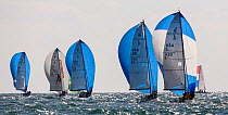 A fleet of sail boats with blue spinnakers racing during 2013 Key West Race Week, Florida. All non-editorial uses must be cleared individually.