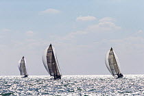 Three boats race with spinnakers out during Key West Race Week 2013, Florida. All non-editorial uses must be cleared individually.