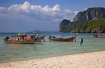Boats in shallow water with distant rocky limestone outcrops, Railay resort, Ao Phra Nang, Ko Poda Island, Krabi Province, Thailand, December 2011.