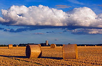 Bales and stubble in field, St James Church in the distance, Southrepps, Norfolk, UK, September 2013.