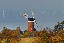 Windmill and North sea wind farm, Weybourne, Norfolk, UK, October 2013.