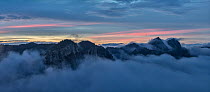 Dolomiti Lucane mountain range at sunset with low clouds. With ski lift cables visible in bottom right, Basilicata, Italy. October 2013.