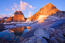 Snowpatch (left) and Bugaboo (right) spires rise above the Crescent glacier at sunrise, Bugaboo Provincial Park, British Columbia, Canada, August.