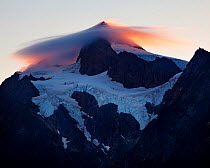 Lenticular cloud on the summit of Mount Shuksan, North Cascades,  Washington, USA. September 2013.