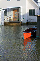 Canoe tethered outside flooded home during February 2014 flooding, Sunbury on Thames, Surrey, England, UK, 15th February 2014.