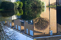 Flooded homes reflected in flood water during February 2014 floods. Surrey, England, UK, 16th February 2014.