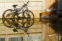 Bike and sandbags in February 2014 flood, Surrey, England, UK, 16th February 2014.