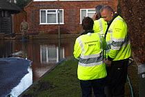 Environment Agency, Army and council officials assisting flooded residents after February 2014 flood from River Thames. Chertsey, Surrey, England, UK, 16th February 2014.