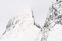 Cloudy winter day at  Leirbreen, with knife edge ridge / arete, on mountain, Jotunheimen National Park, Norway, March.