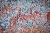 Human figures and wildlife depicted in San bushman rock paintings, estimated at around 2000 years old, Nswatugi Cave, Matobo National Park, Zimbabwe, November 2011.